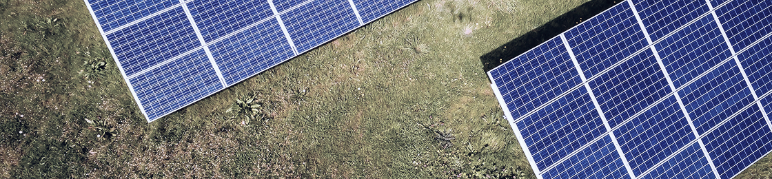 Aerial view of solar panels in a grass field