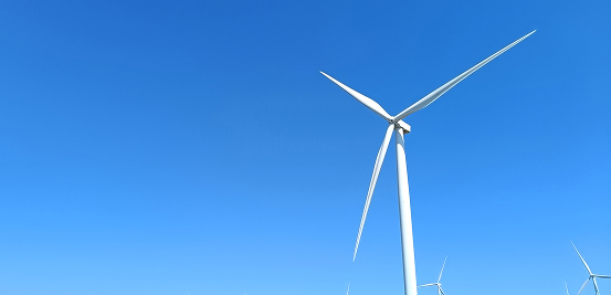 Wind turbine against a blue sky